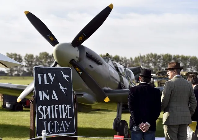 Visitors and car enthusiasts view vintage airplanes at the Goodwood Revival historic motor racing festival in Goodwood, near Chichester in south England, Britain, September 11, 2015. (Photo by Toby Melville/Reuters)