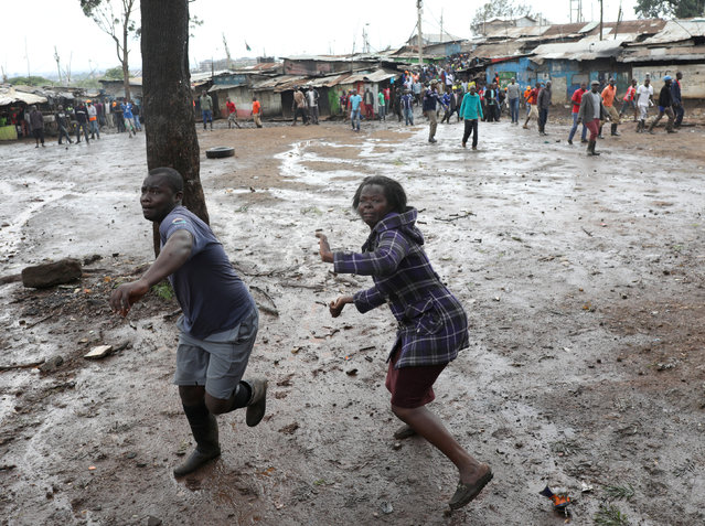 Opposition supporters throw stones at police during clashes in Kibera slum in Nairobi, Kenya on October 26, 2017. (Photo by Goran Tomasevic/Reuters)