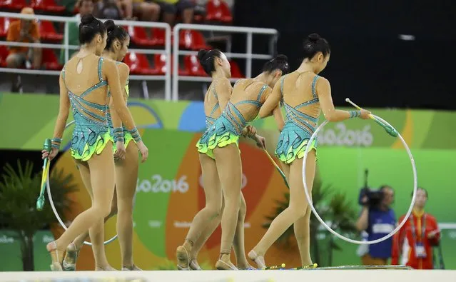 2016 Rio Olympics, Rhythmic Gymnastics, Preliminary, Group All-Around Qualification, Rotation 1, Rio Olympic Arena, Rio de Janeiro, Brazil on August 20, 2016. Team China (CHN) help an injured team mate off the mat after competing using clubs and hoops. (Photo by Mike Blake/Reuters)
