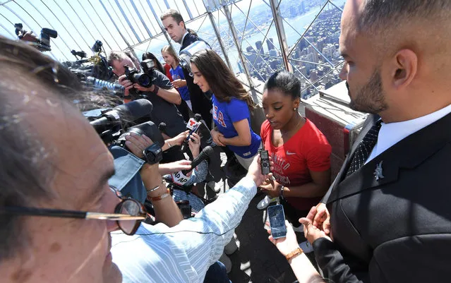 Members of the “Final Five” US Women's Gymnastics Olympic Team, Aly Raisman and Simone Biles (R) speak to the media as they visit the Empire State Building in New York, on August 23, 2016. (Photo by Angela Weiss/AFP Photo)