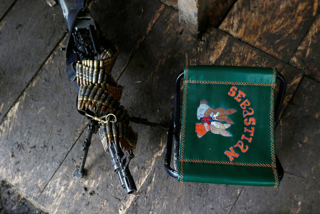 A machine gun and a chair are pictured in at a camp of the 51st Front of the Revolutionary Armed Forces of Colombia (FARC) in Cordillera Oriental, Colombia, August 16, 2016. (Photo by John Vizcaino/Reuters)