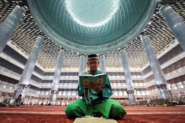 A Muslim man reads the Koran at the Great Mosque of Istiqlal during the holy fasting month of Ramadan in Jakarta, Indonesia, on March 11, 2025. (Photo by Willy Kurniawan/Reuters)