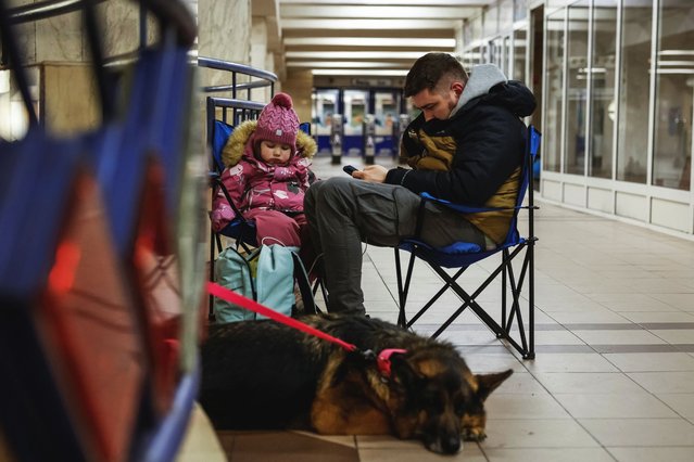 A man with a child and a dog takes shelter inside a metro station during a Russian military strike, amid Russia's attack on Ukraine, in Kyiv, Ukraine on April 6, 2025. (Photo by Alina Smutko/Reuters)