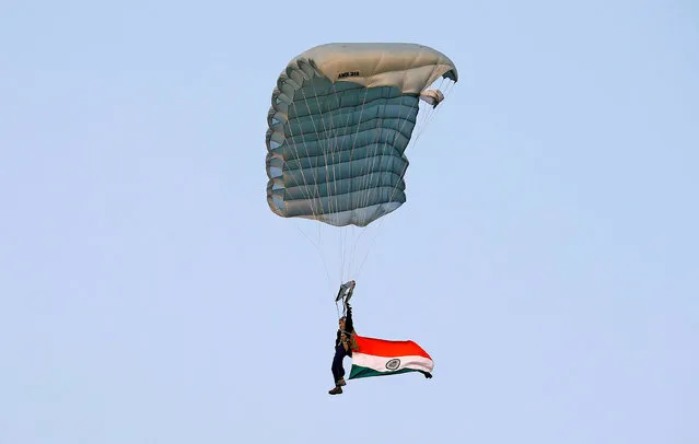An Indian army paratrooper jumps from a plane carrying an Indian national flag during the “Vijay Diwas”, a ceremony to celebrate the liberation of Bangladesh by the Indian Armed Forces on December 16 in 1971, in Kolkata, India December 14, 2017. (Photo by Rupak De Chowdhuri/Reuters)