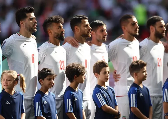Iran players sing the national anthem ahead of a World Cup Group B football match against Wales at Ahmad Bin Ali Stadium in Al Rayyan, Qatar, on November 25, 2022. (Photo by Carl Recine/Reuters)