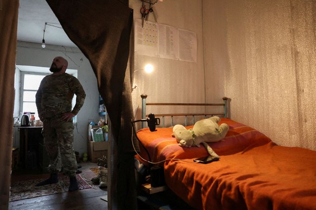 An officer of Ukraine's 2nd Self-Proppelled Battery of the 59th Assault Brigade from the Vinnytsia region, callsign “Black Jack”, on rotation out of the eastern combat zone, pauses outside his bedroom where a stuffed toy belonging to his daughter lies on his bed, at a resting house during a five-day leave in the rear of the frontlines at an undisclosed location in the Dnipropetrovsk region before returning to the Pokrovsk defense effort, in Ukraine, on April 1, 2025. (Photo by Violeta Santos Moura/Reuters)