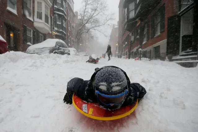 A boy sleds down a Beacon Hill street during Storm Grayson in Boston, Massachusetts, U.S., January 4, 2018. (Photo by Brian Snyder/Reuters)