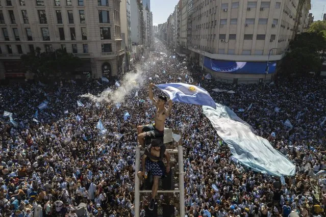 Argentine soccer fans descend on the capital's Obelisk to celebrate their team's World Cup victory over France, in Buenos Aires, Argentina, Sunday, December 18, 2022. (Photo by Rodrigo Abd/AP Photo)