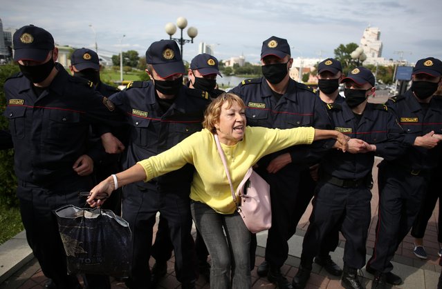 A woman reacts in front of law enforcement officers during a protest of students against presidential election results in Minsk, Belarus on September 1, 2020. (Photo by Tut.By via Reuters)