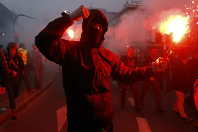 A far-right protester holds a flare during the annual far-right rally, which coincides with Poland's National Independence Day in Warsaw November 11, 2014. (Photo by Kacper Pempel/Reuters)