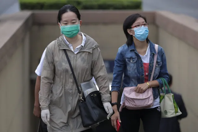 Women wearing face masks to help curb the spread of the coronavirus walk out from a subway station in Beijing, Tuesday, September 15, 2020. Even as China has largely controlled the outbreak, the coronavirus is still surging across other parts of the world. (Photo by Andy Wong/AP Photo)