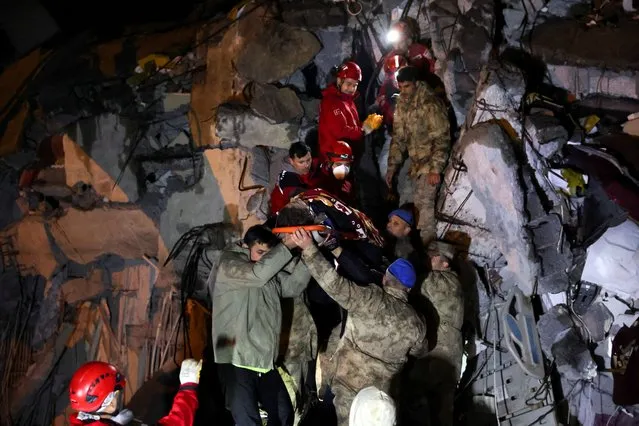 Cennet Sucu is rescued under the rubble of collapsed hospital in Iskenderun, Turkey on February 6, 2023. (Photo by Umit Bektas/Reuters)