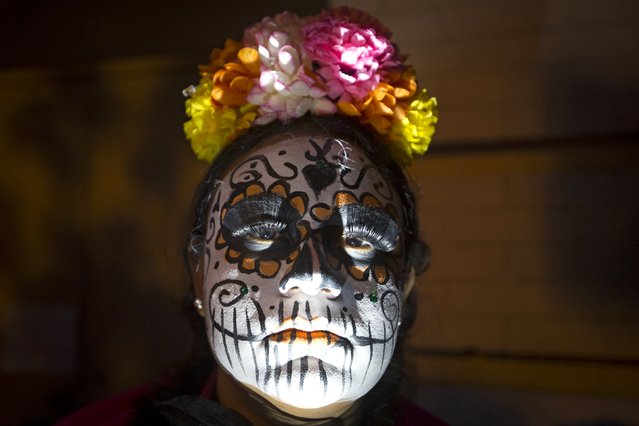 A woman dressed in a "Dia de Muertos" or "Day of the Dead" theme participates in the Greenwich Village Halloween Parade in the Manhattan borough of New York, October 31, 2015. (Photo by Carlo Allegri/Reuters)