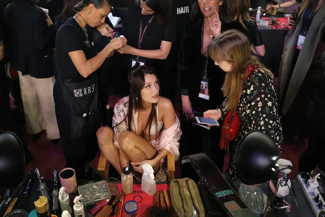 Model Bella Hadid of the United States talks to a woman as she is made up at backstage before the Victoria's Secret fashion show inside the Mercedes-Benz Arena in Shanghai, China, Monday, November 20, 2017. The Victoria's Secret fashion show takes place in Shanghai on Monday with performances from Singer Harry Styles and R&B star Miguel. (Photo by Andy Wong/AP Photo)