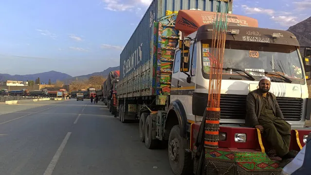 Stranded trucks loaded with supplies for Afghanistan, line up on a highway after Afghan Taliban rulers closed a key border crossing point Torkham, in Landi Kotal, an area Pakistan's district Khyber along Afghan border, Tuesday, February 21, 2023. The main crossing on the Afghan-Pakistan border remained shut Tuesday for the third straight day, officials said, after Afghanistan's Taliban rulers earlier this week closed the key trade route and exchanged fire with Pakistani border guards. (Photo by Qazi Rauf/AP Photo)