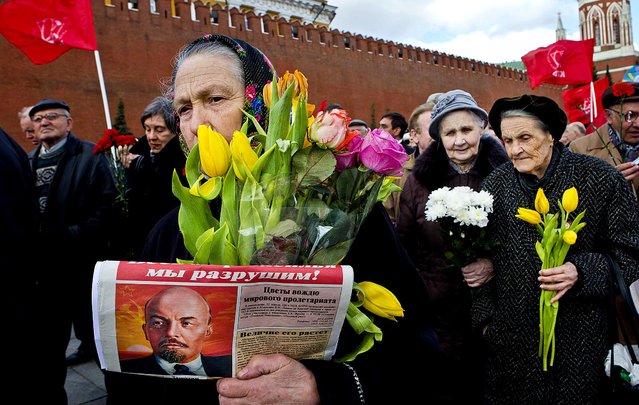 Russian communists and supporters gather in Red Square, with their flags and portraits of Lenin, visit the Mausoleum of the Soviet founder Vladimir Lenin to mark the 143th anniversary of his birth in Moscow, on April 22, 2013. (Photo by Misha Japaridze/Associated Press)