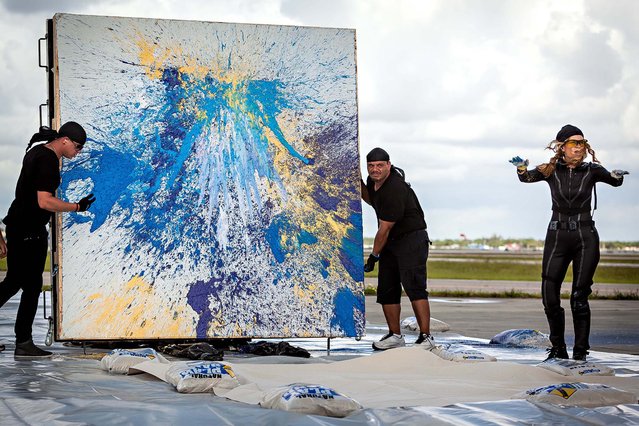 Von Anhalt instructs the pilot to reduce engine power as assistants prepare to move one of her finished paintings. (Photo by Thomas Cordy/The Palm Beach Post)
