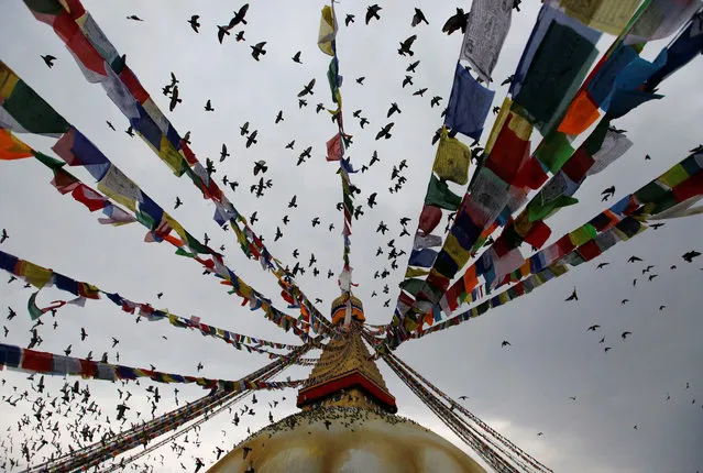 Pigeons take flight at Boudhanath Stupa during the birth anniversary of Buddha, also known as Vesak Day, in Kathmandu, Nepal April 30, 2018. (Photo by Navesh Chitrakar/Reuters)