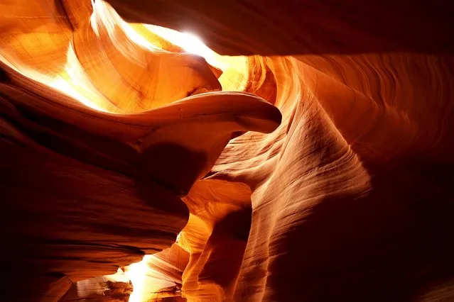 Sandstone sculpted by water and wind erosion is seen in a slot canyon, one of hundreds that surround Lake Powell near Page, Arizona, May 26, 2015. (Photo by Rick Wilking/Reuters)