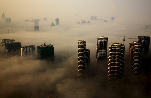 Buildings in construction are seen among mist during a hazy day in Rizhao, Shandong province, China, October 18, 2015. (Photo by Reuters/Stringer)