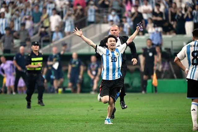 A fan invades the field during a friendly football match between Australia and Argentina at the Workers' Stadium in Beijing on June 15, 2023. (Photo by Wang Zhao/AFP Photo)