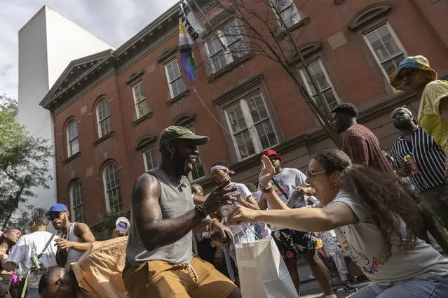 People dance during a Queer Juneteenth Block Party, sponsored by The Center, on Sunday, June 18, 2023, in New York. (Photo by Jeenah Moon/AP Photo)