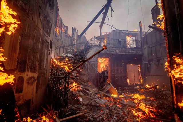 The Palisades Fire burns a residence in the Pacific Palisades neighborhood of Los Angeles, Tuesday, January 7, 2025. (Photo by Ethan Swope/AP Photo)