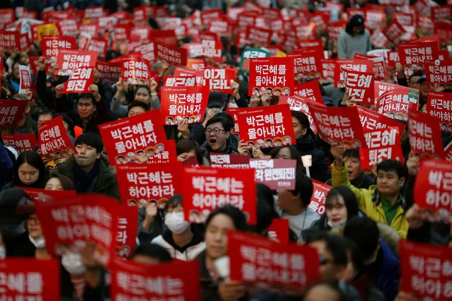 People chant slogans during a protest calling South Korean President Park Geun-hye to step down in Seoul, South Korea, November 19, 2016. The sign reads “Step down Park Geun-hye”. (Photo by Kim Hong-Ji/Reuters)