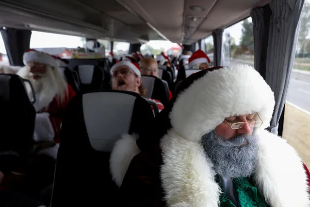 People dressed as Santa Claus rest while on a bus trip between events during the World Santa Claus Congress, an annual event held every summer in Copenhagen, Denmark, July 23, 2018. (Photo by Andrew Kelly/Reuters)