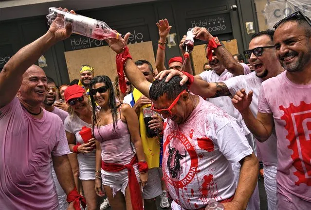 Revellers gather for the “Chupinazo” rocket, which marks the official opening of the 2023 San Fermín fiestas in Pamplona, Spain, Thursday, July 6, 2023. (Photo by Alvaro Barrientos/AP Photo)