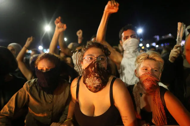 Anti-government demonstrators attend a protest against a constitutional amendment, known as PEC 55, that limit public spending, in front of Brazil's National Congress in Brasilia, Brazil, November 29, 2016. (Photo by Adriano Machado/Reuters)