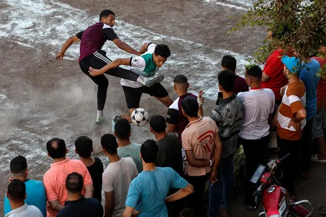 People watch the final football match of the tournament of 32 teams from Tanta, in the village of Damshit in the Nile Delta, some 135km (85 miles) north of Cairo on August 25, 2023. (Photo by Khaled Desouki/AFP Photo)