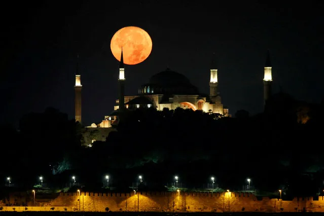 The moon is pictured over the Ayasofya-i Kebir Camii or Hagia Sophia Grand Mosque in Istanbul, Turkey on August 30, 2023. (Photo by Dilara Senkaya/Reuters)