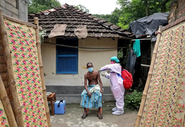 Rafiq Khan, a villager, receives a dose of COVISHIELD vaccine during a door-to-door vaccination and testing drive at Uttar Batora Island in Howrah district in West Bengal state, India, June 21, 2021. (Photo by Rupak De Chowdhuri/Reuters)