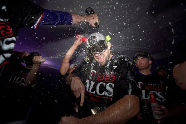 Texas Rangers starting pitcher Nathan Eovaldi celebrates with teammates after winning an American League Division Series baseball game against the Baltimore Orioles in Arlington, Texas, Tuesday, October 10, 2023. (Photo by Julio Cortez/AP Photo)