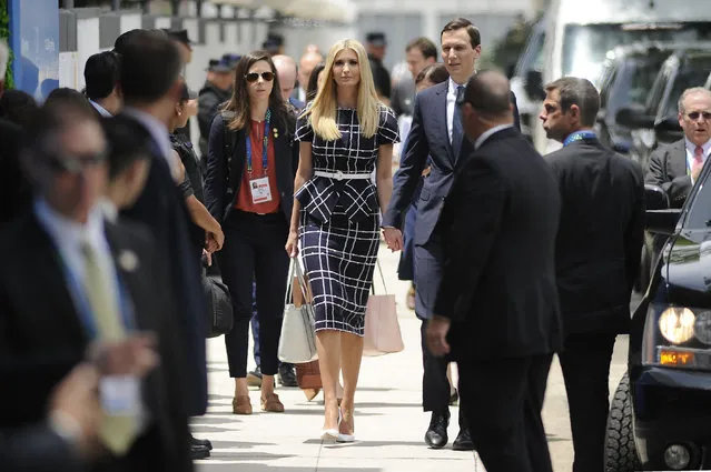 White House adviser and US President Donald Trump's daughter Ivanka Trump (C) and her husband Senior Advisor Jared Kushner (R), arrive at Costa Salguero in Buenos Aires to attend the G20 Leaders' Summit, on November 30, 2018. G20 powers open two days of summit talks on Friday after a stormy buildup dominated by tensions with Russia and US President Donald Trump's combative stance on trade and climate fears. (Photo by Javier Gonzalez Toledo/AFP Photo)