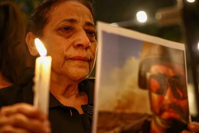 Aunt of Issam Abdallah, a Reuters video journalist who was killed in southern Lebanon while filming an Israeli tank firing into Lebanon, reacts during a candlelight vigil, in Beirut, Lebanon on October 20, 2023. (Photo by Amr Alfiky/Reuters)