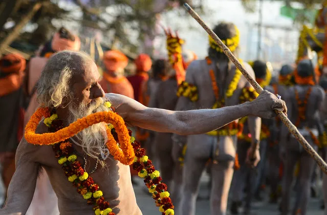 An Indian elderly naked sadhu (Hindu holy man) gestures as he takes part in a religious procession towards the Sangam area during the “royal entry” for the upcoming Kumbh Mela festival in Allahabad on January 4, 2019. The festival attracts millions of Hindu pilgrims to the sacred confluence of the Yamuna and Ganges rivers over 49 days between January 15 and March 4. (Photo by Sanjay Kanojia/AFP Photo)
