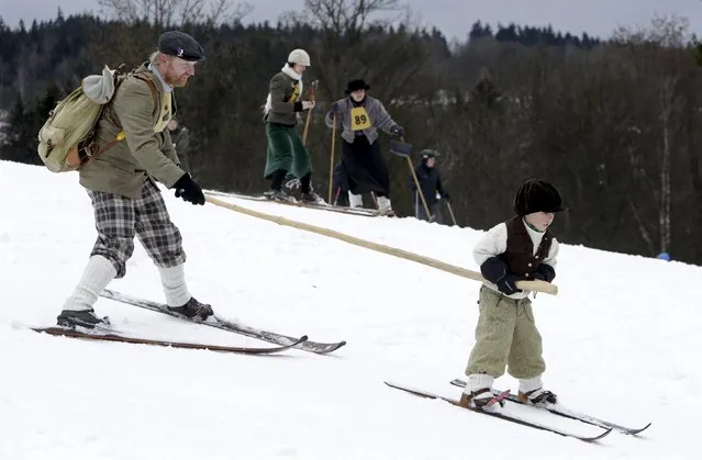 Participants wearing vintage attire arrive for a traditional historical ski race in the northern Bohemian town of Smrzovka, Czech Republic, February 20, 2016. (Photo by David W. Cerny/Reuters)