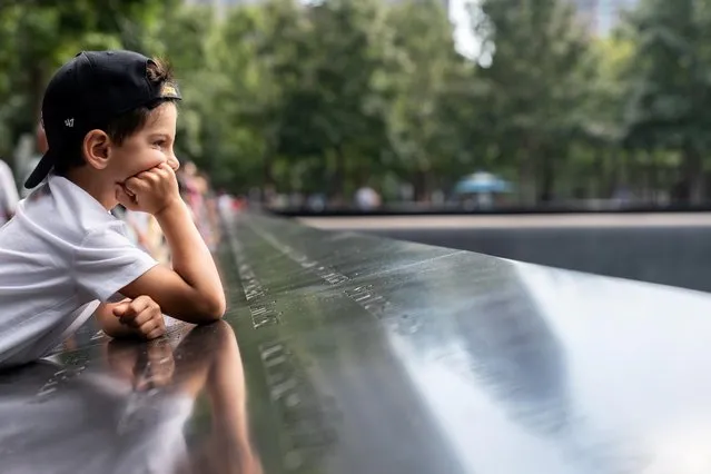 Aiden Joel, 7, stands at the names of victims at the National September 11 Memorial & Museum, on the day Taliban insurgents entered Afghanistan's capital Kabul, in New York City, New York, U.S., August 15, 2021. (Photo by Jeenah Moon/Reuters)