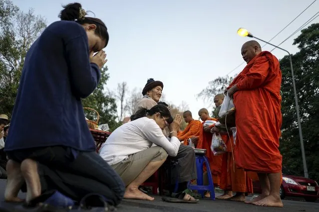 Buddhists pay their respects to buddhist monks during Makha Bucha day near Wat Phrathat Doi Suthep in the northern capital of Chiang Mai, Thailand, February 22, 2016. (Photo by Athit Perawongmetha/Reuters)