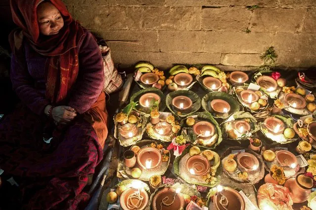 Nepalese devotees release oil lamps in memory of deceased family members during the Balachaturdashi festival at Pashupati temple in Kathmandu, Nepal, 06 December 2018. Thousands people from all over the country have gathered at the Pasupati temple to light the oil lamps at the Bagmati river in the name of their departed beloved ones during the year. The following morning family members will spread Satabij, seven kinds of seeds-paddy, barley, sesame, wheat, gram, maize and finger millet, around the temple premises. Seeds are sown with the belief that the departed souls receive salvation. (Photo by Narendra Shrestha/EPA/EFE)