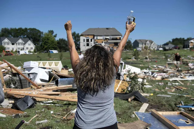 Ashley Thomas cheers upon finding her purse after her home was damaged  by a tornado in Mullica Hill, N.J. Thursday, September 2, 2021. A stunned U.S. East Coast woke up Thursday to a rising death toll, surging rivers and destruction after the remnants of Hurricane Ida walloped the region with record-breaking rain, filling low-lying apartments with water and turning roads into car-swallowing canals. (Photo by Joe Lamberti/Camden Courier-Post via AP Photo)