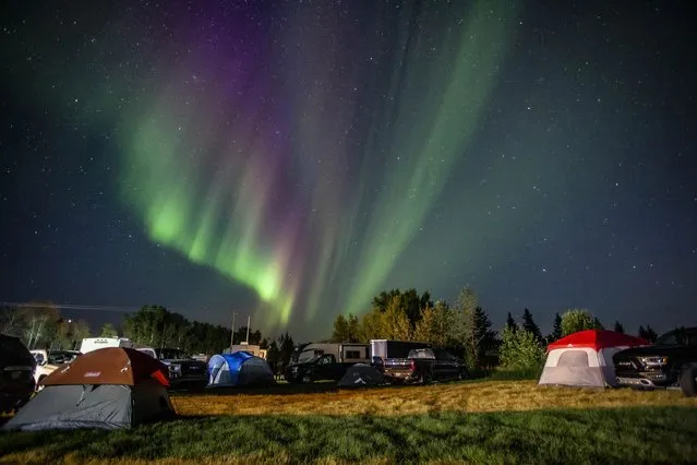 Evacuees from Yellowknife, territorial capital of the Northwest Territories, are greeted with the Aurora Borealis as they arrive to a free campsite provided by the community in High Level, Alta., Friday, August 18, 2023.  (Photo by Jason Franson/The Canadian Press via AP Photo)
