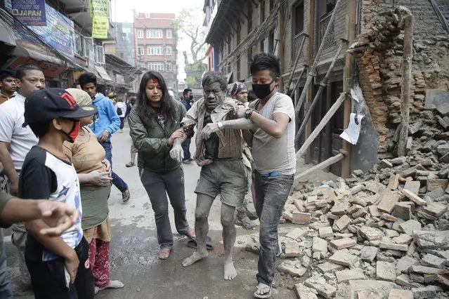 People free a man from the rubble of a destroyed building after an earthquake hit Nepal, in Kathmandu, Nepal, 25 April 2015. (Photo by Narendra Shrestha/EPA)