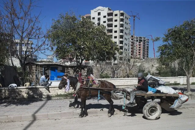 In this photo taken on Tuesday, March 1, 2016, a man rides a carriage in Latakia, Syria. Associated Press spent five days traveling through the port of Latakia in Syria during the cease-fire. (Photo by Pavel Golovkin/AP Photo)