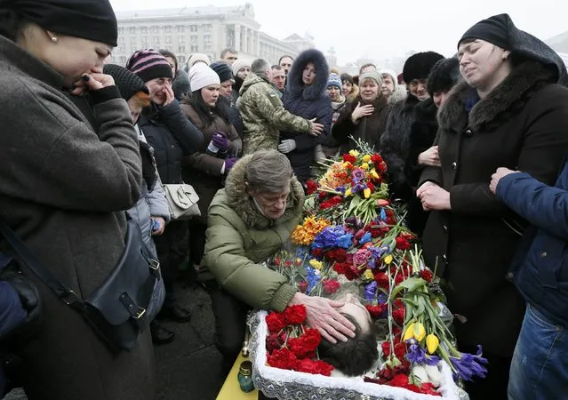 Mourners react during a funeral ceremony for the seven Ukrainian servicemen, who were recently killed during a military conflict in the east of the country, in Independence Square in central Kiev, Ukraine, February 1, 2017. (Photo by Valentyn Ogirenko/Reuters)