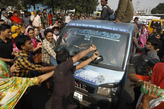 Bangladeshi garment workers vandalize a vehicle during a protest in Savar, on the outskirts of Dhaka, Bangladesh, Wednesday, January 9, 2019. Thousands of garment workers have staged demonstrations to demand better wages for the fourth straight day, shutting down factories on the outskirts of Bangladesh's capital. Bangladesh has the second-largest garment-export industry in the world after China and makes clothes for big-name retailers. (Photo by AP Photo/Stringer)