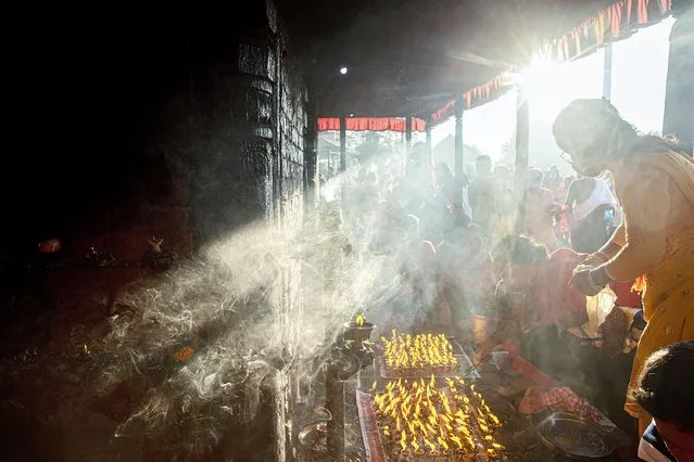 Nepalese devotees worship during Dashain Festival celebrations at the Baramahini Temple in Bhaktapur, Nepal, 15 October 2021. During the 15-day Dashain Festival, Nepalese Hindu devotees worship Durga, a mother goddess of power and prosperity, offering animal sacrifices, especially goats and buffalo. In general, the Dashain Hindu festival is a celebration of the victory of the gods over demons and the victory of good over evil. (Photo by Narendra Shrestha/EPA/EFE)