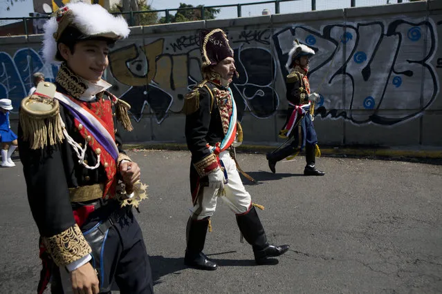 Mexicans playing the part of French military officers, including Napolean III, center, march in a parade before a reenactment of the battle of Puebla, between Zacapoaxtla Indians and the French army, during Cinco de Mayo celebrations in Mexico City, Tuesday, May 5, 2015. (Photo by Rebecca Blackwell/AP Photo)